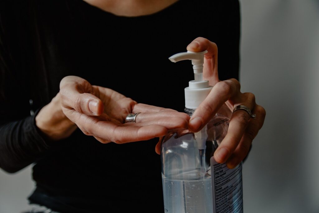 [woman with bottle of hand sanitizer]